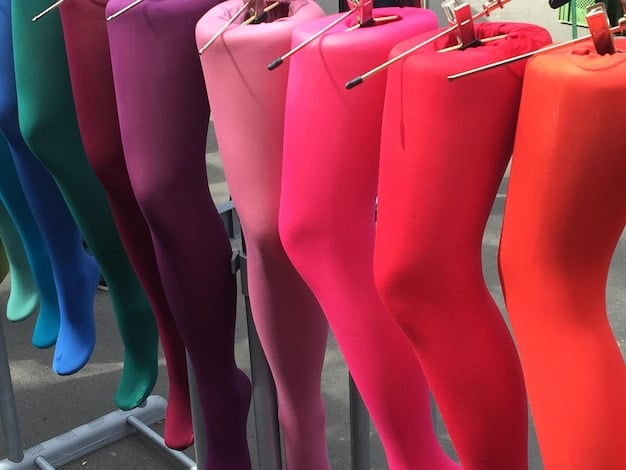 A close-up shot of various stylish leggings in different colors and textures, including high-waisted options, textured leggings, and leggings with mesh panels, displayed on a rack in a boutique.
