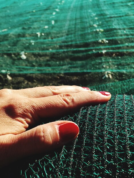 A close-up shot of a textile innovator presenting a fabric swatch made from recycled ocean plastic at a sustainable fashion conference, highlighting the use of innovative materials.