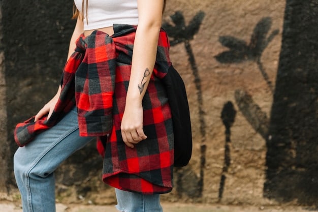 A close-up of a woman wearing a modern grunge outfit, featuring an oversized flannel shirt, straight-leg distressed jeans, and black combat boots, with a focus on the texture and details of the clothing.