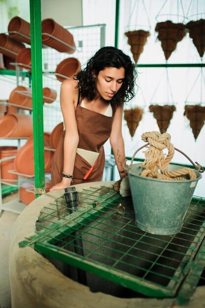 An image of a worker in a fair-trade garment factory using natural dyes on organic cotton fabric. The setting is clean, well-lit, and reflects a commitment to ethical and sustainable production practices.