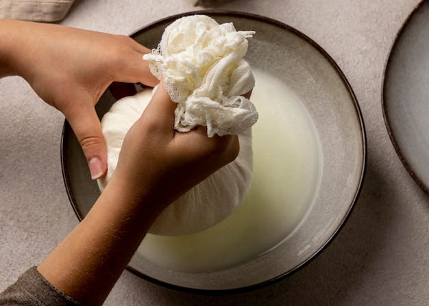 Close-up shot of hands gently washing a delicate silk scarf in a basin with soapy water. The focus is on the texture of the fabric and the careful handling.