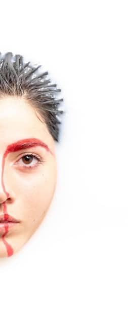 A split image showing one eye with the drugstore mascara applied and the other eye with the high-end mascara applied. The lashes should be clearly visible, showcasing the differences in volume, length, and separation after the first coat.