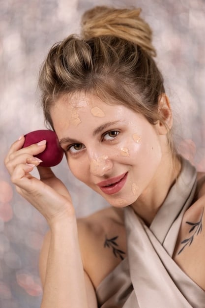 A woman applying Formula One foundation with a damp sponge, showcasing the luminous finish on her skin. The background features the foundation bottle and key ingredients highlighted.
