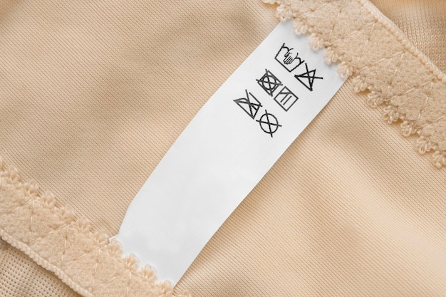 A close-up image of a Shein clothing tag still attached to a garment, emphasizing the importance of keeping tags on for returns.