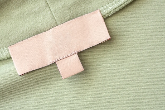 Close-up shot of a clothing label on a garment from Shein's Sustainable Collection. The label clearly indicates the use of recycled materials, such as recycled polyester or organic cotton. This highlights Shein's commitment to using eco-friendly fabrics.