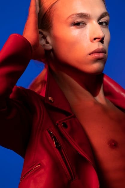 Close-up shot of a model showcasing avant-garde layering techniques inspired by Rihanna. The model is wearing an oversized coat with multiple layers of sheer fabrics, deconstructed blazer, and edgy skirt. Focus on the textures and combinations.