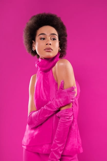 Rihanna confidently posing in a vibrant, color-blocked outfit consisting of a bright pink blazer, electric blue pants, and neon green heels. The outfit embodies the trend of bold and vibrant colors, showcasing a mix of textures and patterns.