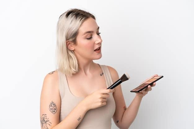 A person applying subtle highlighter to their cheekbone, demonstrating a technique for achieving a natural, glowing makeup look inspired by celebrities.